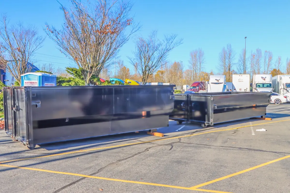 Professional dumpster rental service with roll-off container on residential driveway in Creswell